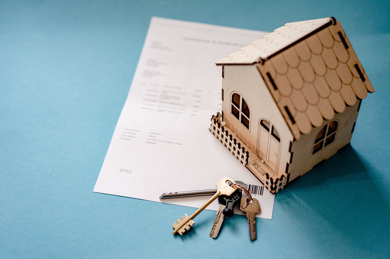 A close-up of a signed residential lease agreement with apartment keys resting on top of the paperwork.